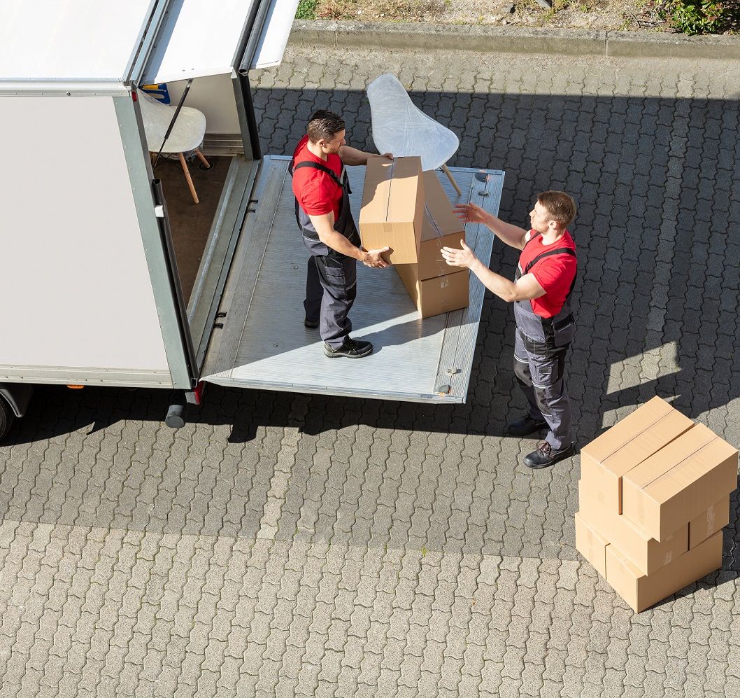 Calgary moving company VC Movers loading a customer's belongings onto the truck ramp