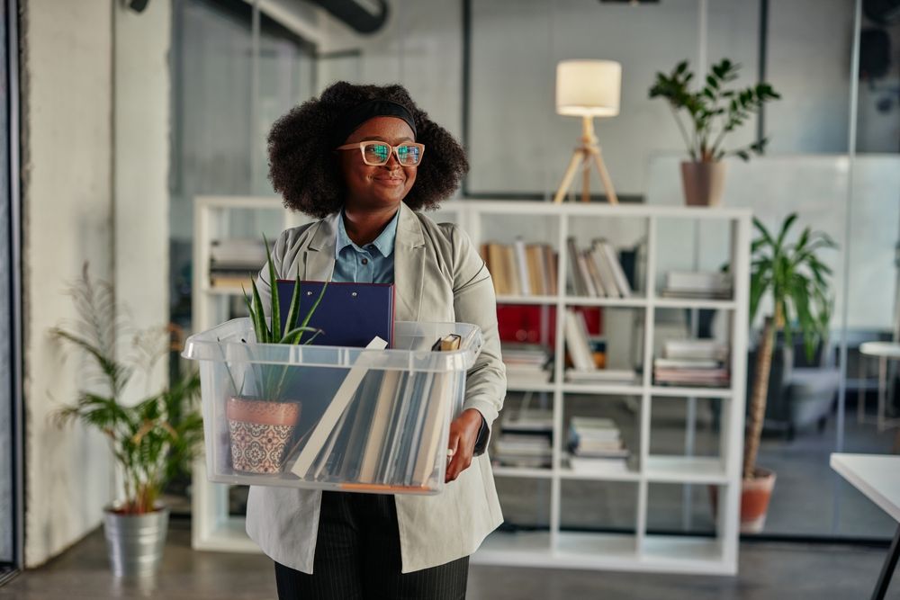 A customer carrying a crate of files during an office move